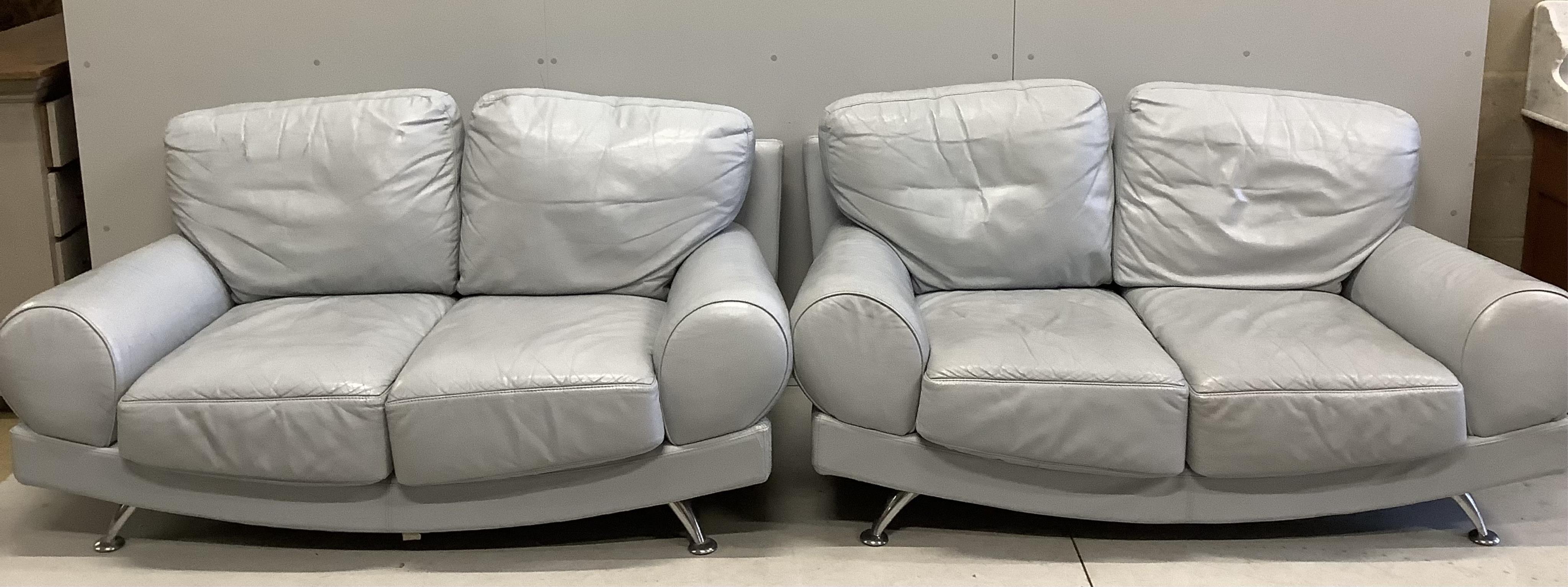 A pair of Contemporary Italian style pale blue leather sofas, width 160cm, depth 84cm, height 80cm. Condition - poor to fair